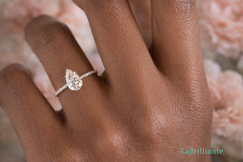 Elegant Pear Lab-Grown Diamond Engagement Ring on Hand - Showcasing the teardrop silhouette in a platinum solitaire setting with natural lighting, demonstrating finger-flattering proportions and brilliance to capture reader attention immediately