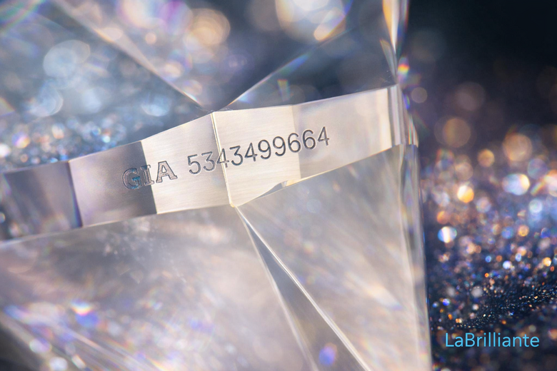 Laser Inscription Under Magnification - Shows actual microscopic view of girdle inscription with certificate number, demonstrating verification method buyers can use